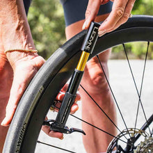 Load image into Gallery viewer, Lezyne Presta Pocket Drive Mini Pump Person using a bicycle pump to inflate a tire outdoors