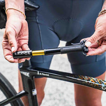 Load image into Gallery viewer, Person using a Lezyne Presta Pocket Drive Mini Pump on a bicycle